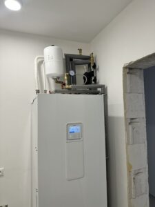 Montáž vnútornej jednotky tepelného čerpadla s expanznou nádobou v novostavbe rodinného domu.